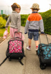 Two kids with suitcases 